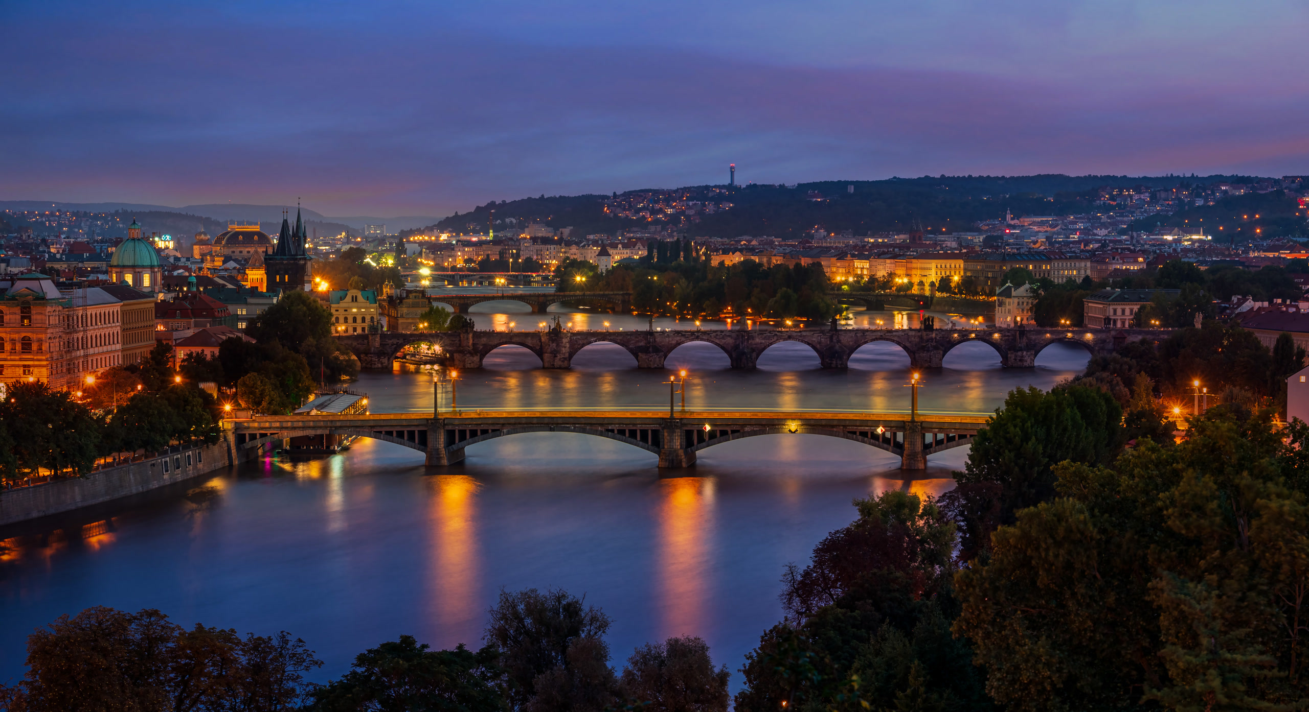 Prague's Vltava bridges at dusk seen from Letná Park; the bridge sequence is Prague's. Czech Republic, Offshore BPO Confidence Index 2023