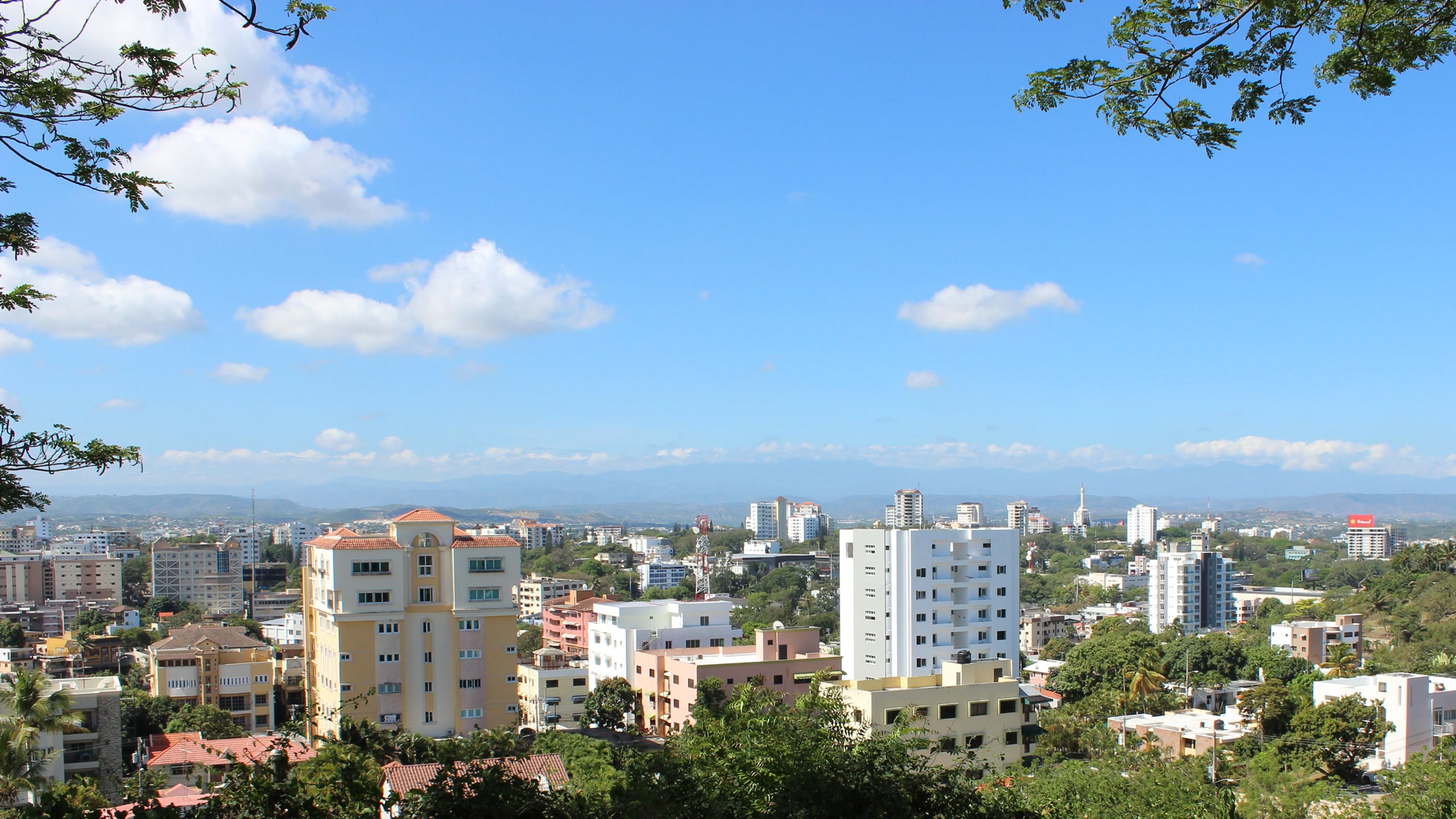 Low-rise Santiago de los Caballeros with apartment towers and the Cordillera behind; in the Commons category for Santiago's skyline. Dominican Republic, Offshore BPO Confidence Index 2023