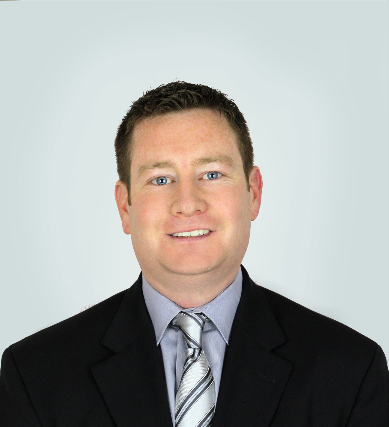 Scott Newman, CEO, Transparent BPO, Belize, Offshore BPO Confidence Index 2023: Smiling man in a dark suit and striped tie against a plain light gray background
