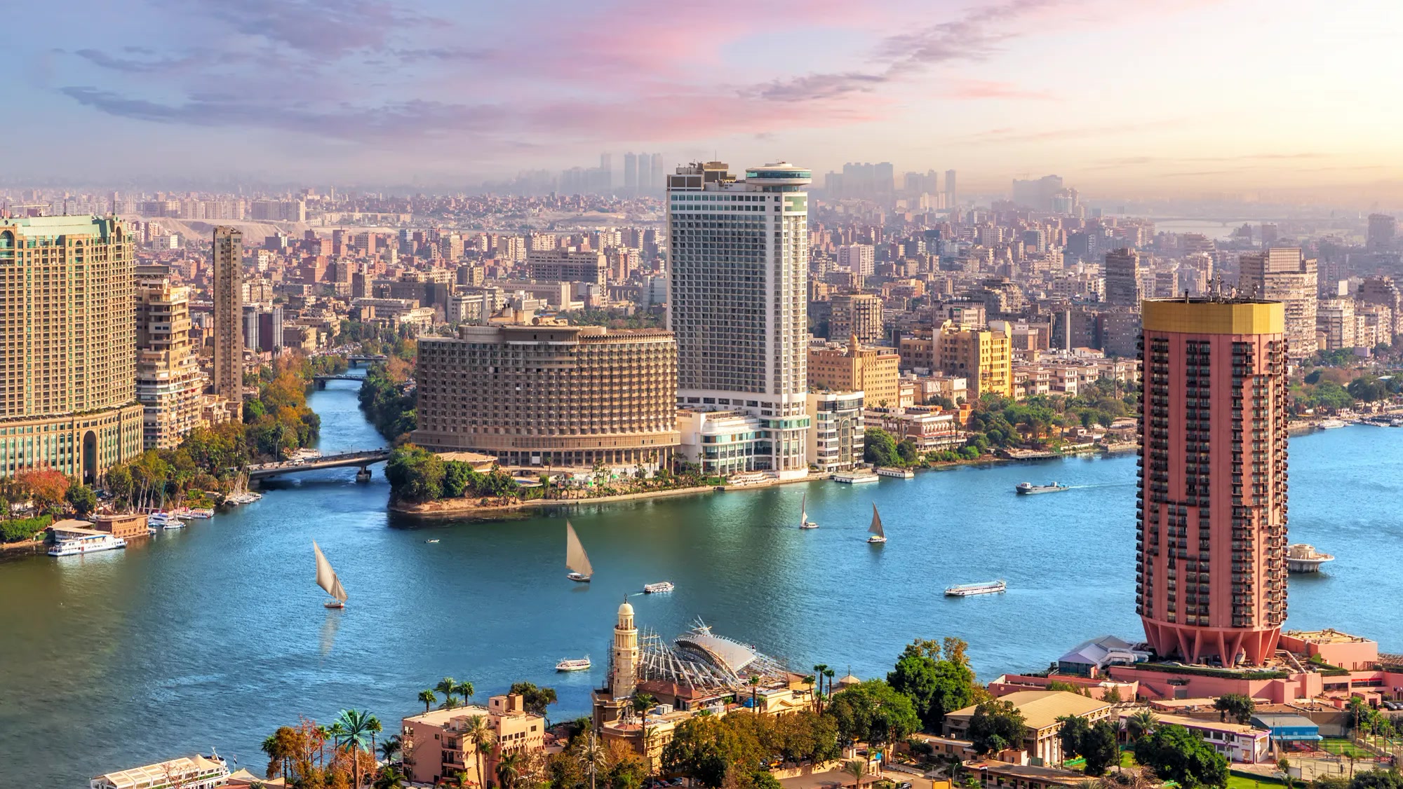 Aerial view of Cairo, Egypt at sunset with the Nile River, sailboats, and high-rise towers. Egypt, Offshore BPO Confidence Index 2024