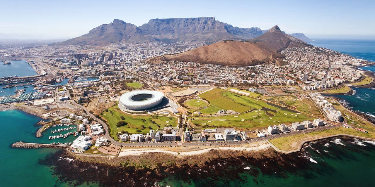 Aerial view of Cape Town, South Africa with Table Mountain, a white stadium, and the coastline. South Africa, Offshore BPO Confidence Index 2024