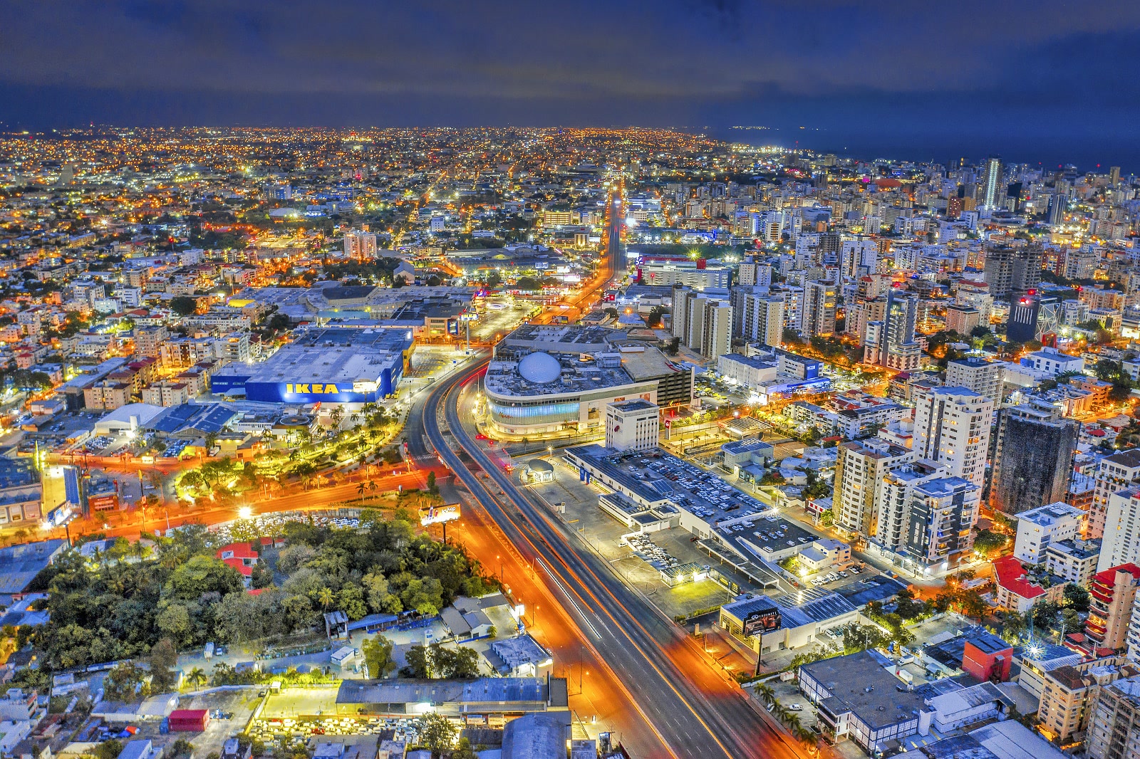 Aerial night view of Santo Domingo, Dominican Republic, with lit streets, high-rise towers. Dominican Republic, Offshore BPO Confidence Index 2024