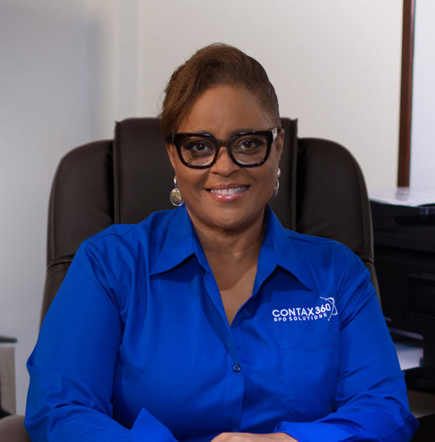 Jackie Sutherland, President & CEO, Contax360 BPO Solutions, Jamaica, Offshore CX Confidence Index 2025: Smiling woman in black-framed glasses and a blue shirt, seated in a brown office chair